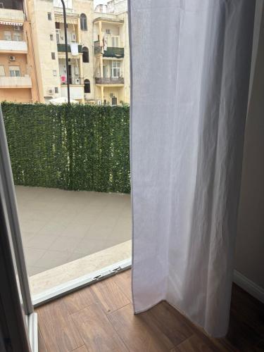 an open door to a balcony with a white curtain at Casa Rachele in Taranto