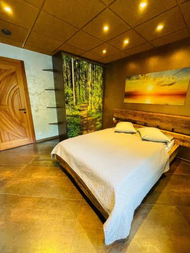 a bedroom with a large bed with a large window at BRIVIBAS RESIDENCE - SUNSET, free PRIVAT parking, free WIFI, self check-in in Rīga