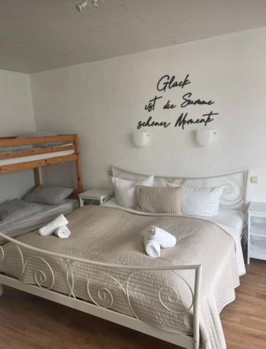 a bedroom with two beds and a sign on the wall at Ferienpark-Canow in Canow