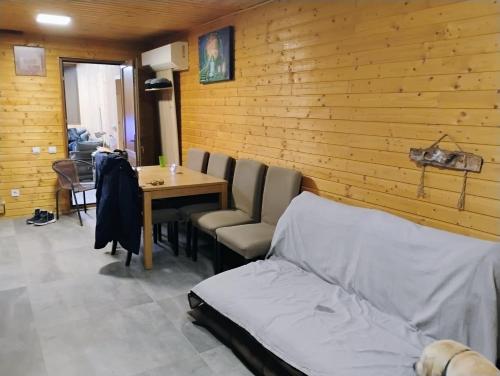 a room with a bed and a table and chairs at Cabana Elena - Private SPA in Brădetu