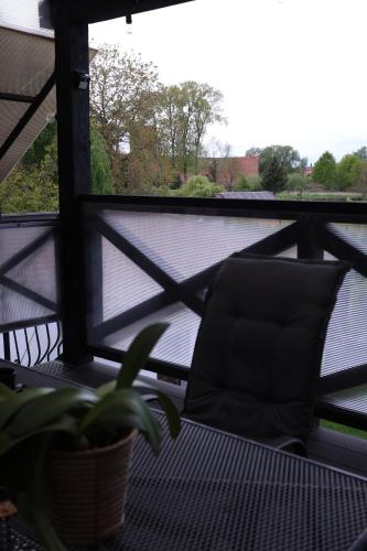 a chair sitting on a balcony with a view at The Castle Terrace Apartment 100m2 in Ciechanów