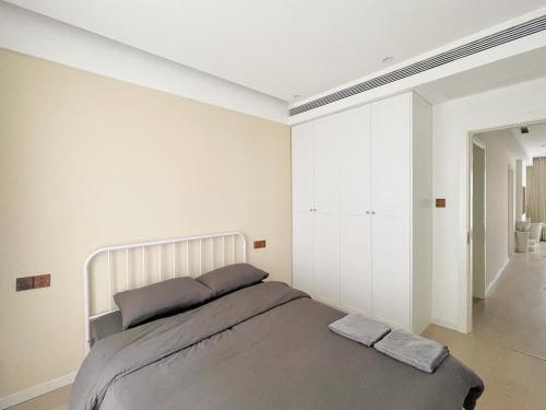 a bedroom with a large bed with two pillows at Pure Home-Near the Bund enjoys the beautiful scenery of the Bund 3-bedhome close to Yuyuan Garden Huaihai Road and Nanjing Road Pedestrian Street in Shanghai