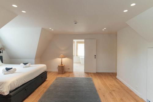 a bedroom with a large bed and a bathroom at Villa 'La Mer Veille - Bécassine' in Oostduinkerke - Bad in Oostduinkerke