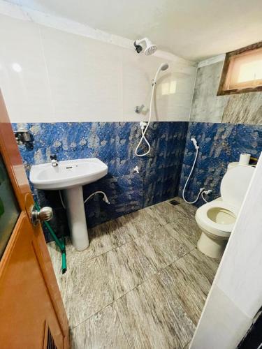 a bathroom with a toilet and a sink at Dream Villa Homestay Madiha in Matara