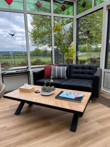 a living room with a couch and a coffee table at Habitat in Momignies