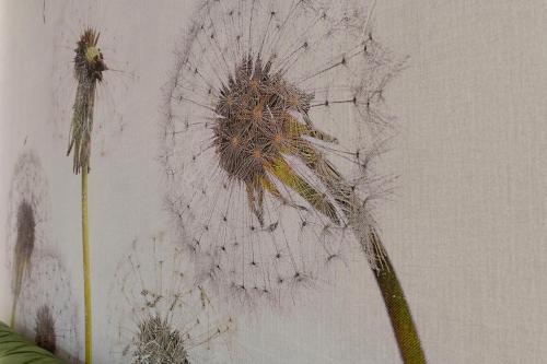 a painting of a flower on a wall at MILLE SUITE GARDEN in Noto