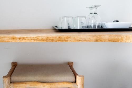 a wooden shelf with a chair on top of it at The Summit of Mykonos in Kalo Livadi