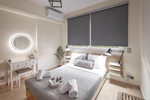 a bedroom with a large bed with towels on it at Xenia Serenity in Kalamata