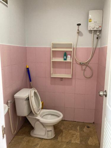 a pink bathroom with a toilet and a shower at Sea Salt 2 Cozy Studio with full kitchen and Fast Wifi in Thong Sala