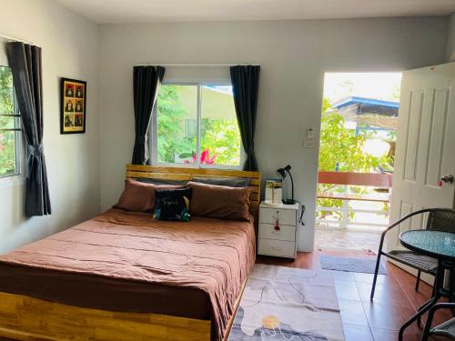 a bedroom with a bed with a purse on it at Sea Salt 2 Cozy Studio with full kitchen and Fast Wifi in Thong Sala