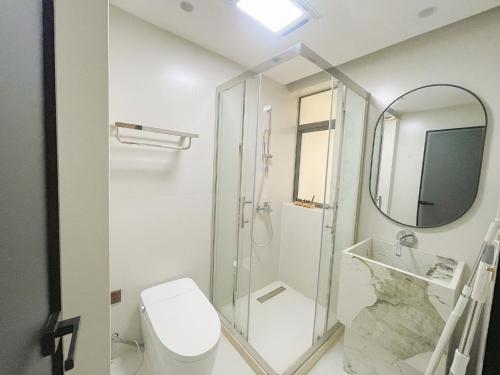 a bathroom with a shower and a toilet and a mirror at Pure Home-Near the Bund enjoys the beautiful scenery of the Bund 3-bedhome close to Yuyuan Garden Huaihai Road and Nanjing Road Pedestrian Street in Shanghai
