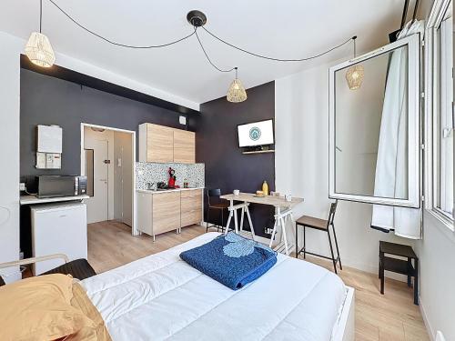 une chambre avec un grand lit et une cuisine dans l'établissement Studio recent et moderne parking fibre Ker Vern, à Brest