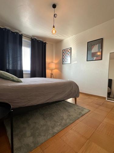 a bedroom with a large bed and a window at Montreux centre appartement avec vue lac in Montreux