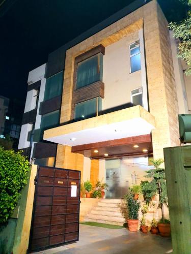 a large house with a gate in front of it at Hotel Merriment Alpha in Noida