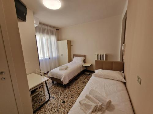 Ένα ή περισσότερα κρεβάτια σε δωμάτιο στο Albergo D'Ambros - Casa Belfiore Group
