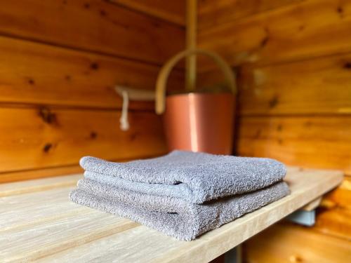 a pile of towels sitting on a wooden table at Parádsasvári Sasfészek in Parád