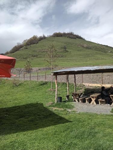 a picnic table with a hill in the background at Sweet home in Lalkhori