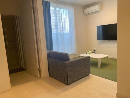 a living room with a chair and a television at Camper in Kumamoto