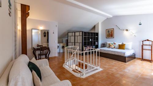 a living room with a couch and a bed and a table at Marquinhos do Mar by AcasaDasCasas in Ericeira