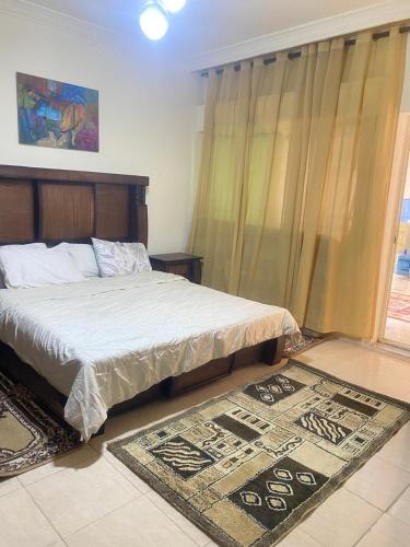 a bedroom with a bed and a rug on the floor at شقه بغرفه وصاله وبلكونه بدون شراكة in Amman