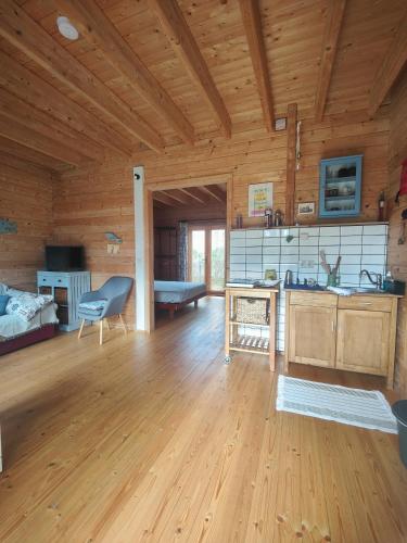 a kitchen and living room with wooden walls and wooden floors at O Gato do Campo in Viana do Castelo