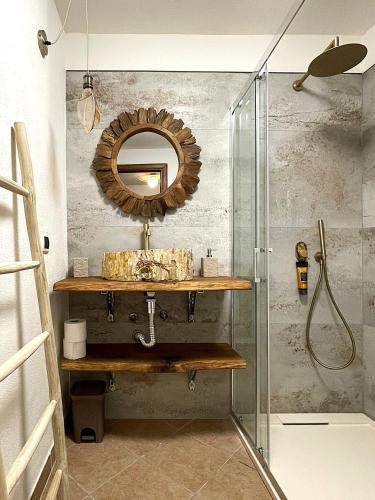 a bathroom with a sink and a mirror at Villa Allegria, romantic luxury 300m from the beach, heated pool, firepit and sauna in Tanaunella