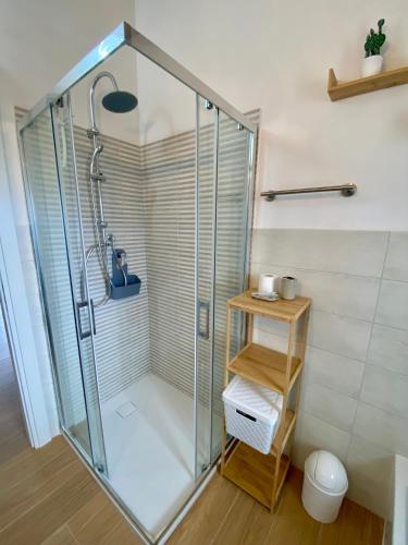 a shower with a glass door in a bathroom at Appartamento in centro paese in Monterosi