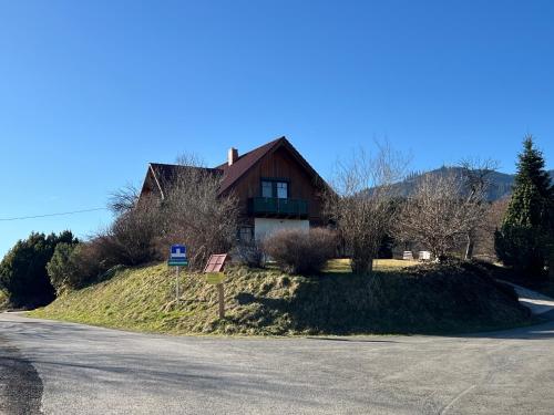 a house sitting on top of a hill next to a road at Haus am Ring in Spielberg
