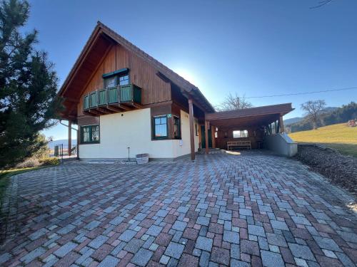 a house with a brick driveway in front of it at Haus am Ring in Spielberg