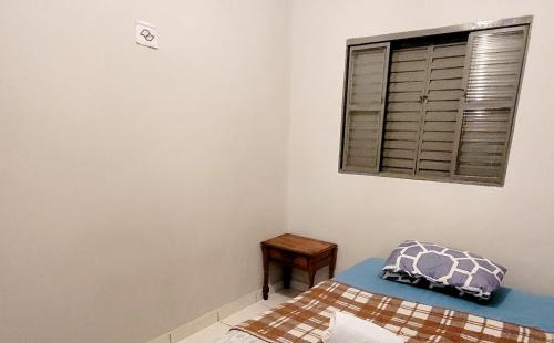a bedroom with a bed and a window at sss in Campinas