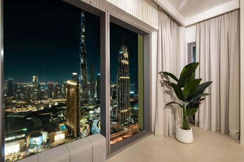 a room with a window with a view of the city at Dubai Mall Connection - Burj Views - Turf Balcony in Dubai