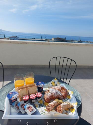 a tray of food on a table with orange juice at Sikelia Suite Rooftop in Porto Empedocle