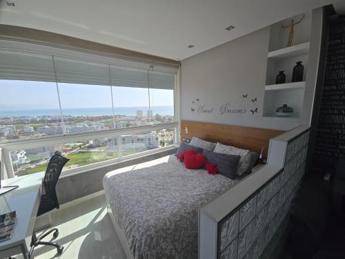 a bedroom with a bed and a large window at Estudio III VISTAS MAR, TREN Y MALAGA in Torremolinos