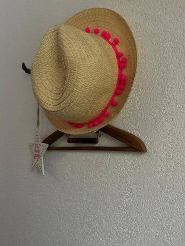 a straw hat hanging on a wall with a star at Willa Dolce Vita in Szczyrk