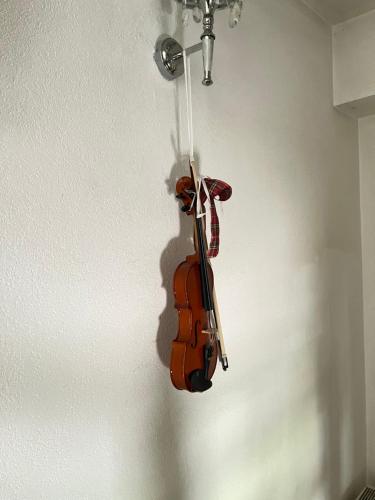 a violin is hanging on a wall at Willa Dolce Vita in Szczyrk