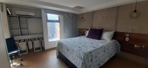 a bedroom with a bed and a television in it at Luxury Laureles-LA 70-Medellin Stunner in Medellín