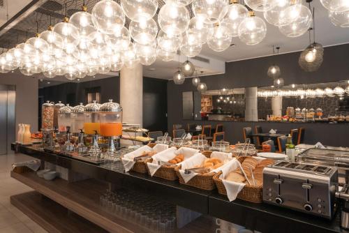 a buffet line with baskets of food and lights at Frontier Hotel Rivera in Rivera