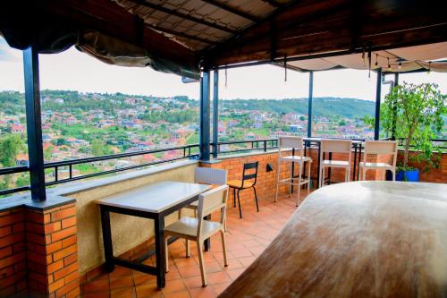 a restaurant with tables and chairs and a view at Quality Inn Hotel Kigali in Kigali