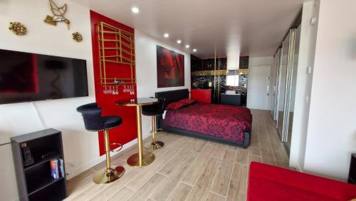 a bedroom with a red bed and a red wall at Cap sur le Paradis in Cap d'Agde