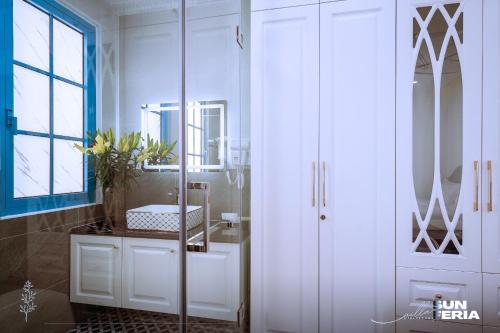 a bathroom with a white cabinet and a mirror at Hoài An Villa - Biệt thự 7 Pngủ - 100m đến bãi biển in Ha Long