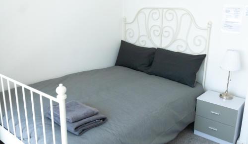 a bedroom with a white bed with a white headboard at Comfortable stay in Shirley, Solihull - Room-2 in Solihull