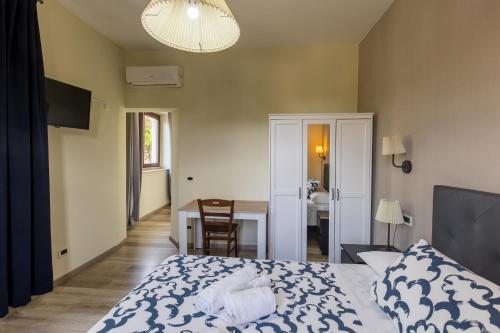 a bedroom with a bed and a table and a desk at Palazzo Santori in Tivoli