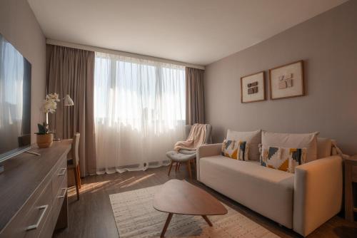 a living room with a couch and a window at Frontier Hotel Rivera in Rivera