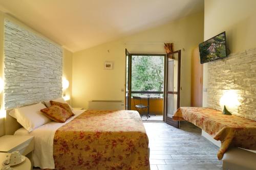 a hotel room with two beds and a window at Pidkova in Modena