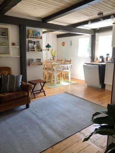 a living room with a couch and a table at Close to nature in cozy old mill in Timmersdala