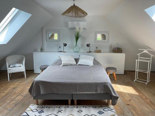 a bedroom with a large bed in a attic at Chez Julie in Le Monteil
