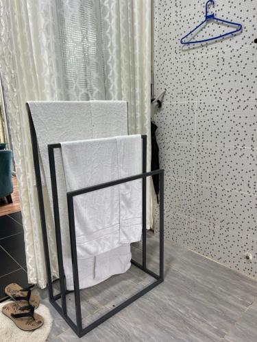 a towel rack with towels on it in a bathroom at Twenty ritz cottage in Migori
