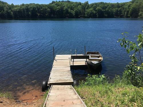 a boat is docked at a dock on a lake at The Hideaway on Clear Lake Island in Hayward