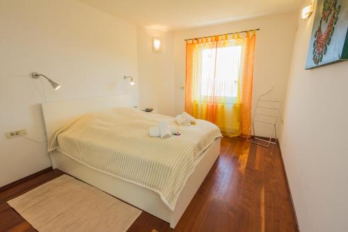 Postel nebo postele na pokoji v ubytování Apartments Villa Dinka