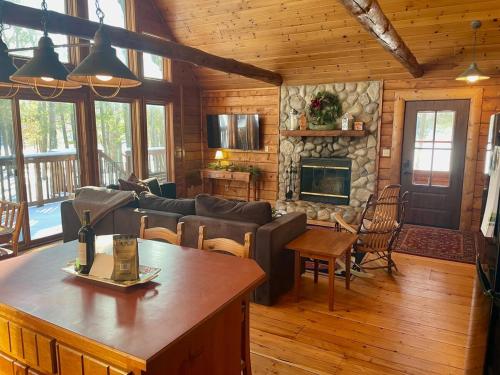 a living room with a couch and a fireplace at The Hideaway on Clear Lake Island in Hayward